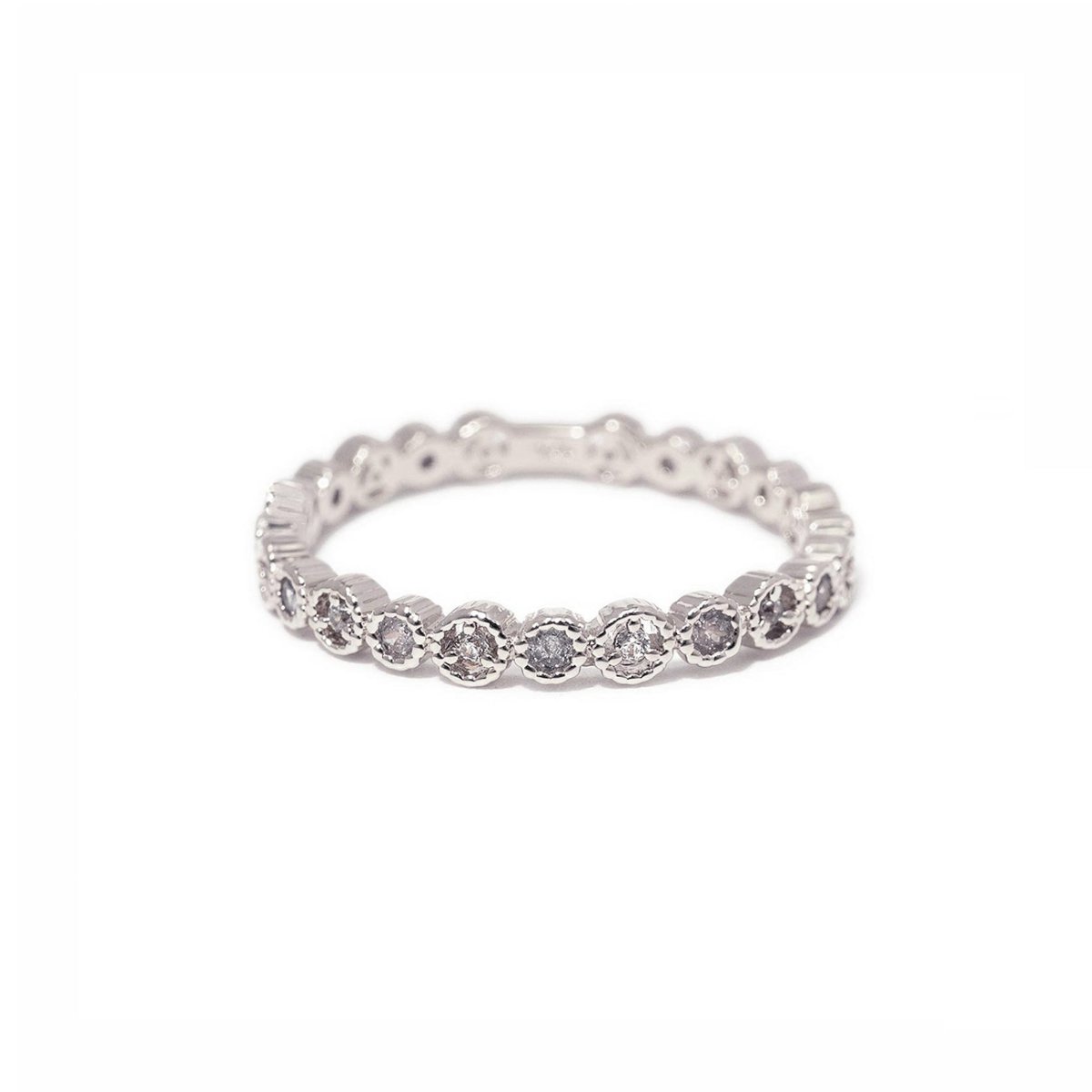 Sterling silver eternity stacking ring with round white zirconia in a beaded setting, on a white background