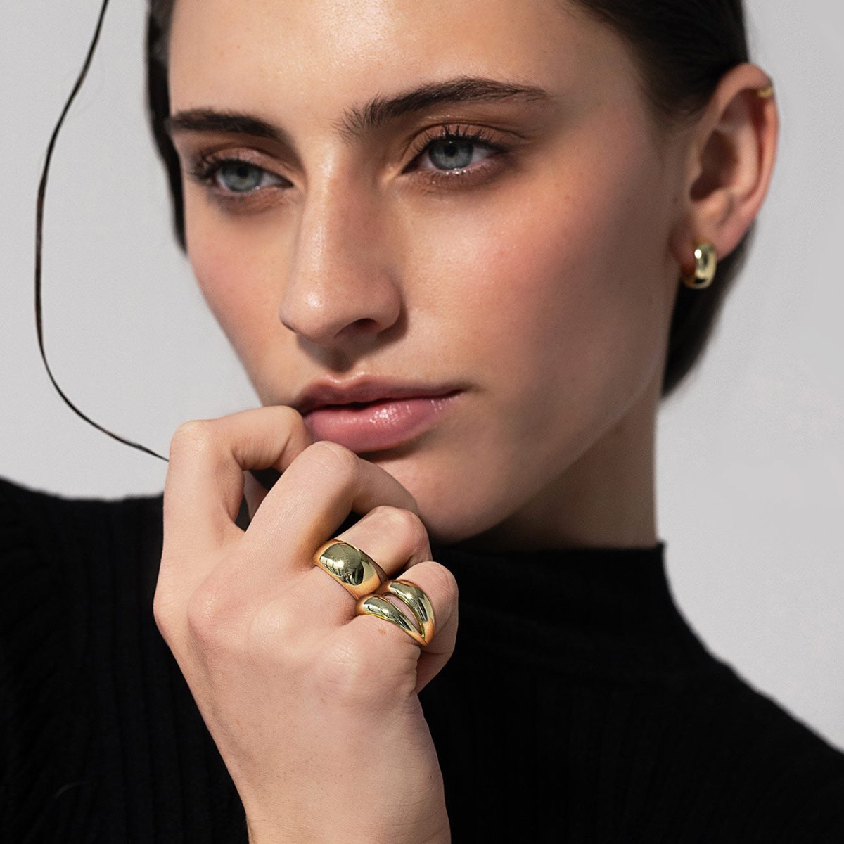 Model wearing statement rings by AMYO: Bold Dome and Double Dome Ring in Sterling Silver