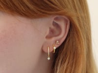 Video of woman's side profile of woman featuring Gold Vermeil Gemstone Bead Huggies Opal, hoop, and stud.