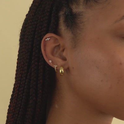 A slow panel of model's gold ear stack. Featuring Amyo Jewelry's collection of gold vermeil & 14K white gold earrings.  