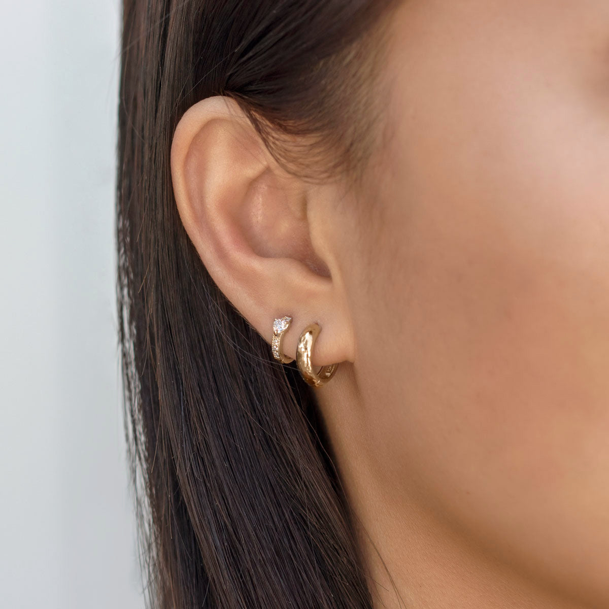 Chunky Gold Hoops paired with tiny pave heart huggie earring