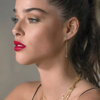 Model wearing Dainty Gold Cubic Zirconia Dangle Earrings 