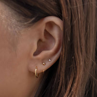 Gold Huggie Hoop Earrings with Tiny Crystal Stud in an Ear Stack