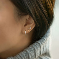 caption: Model wearing 8.5mm on first piercing