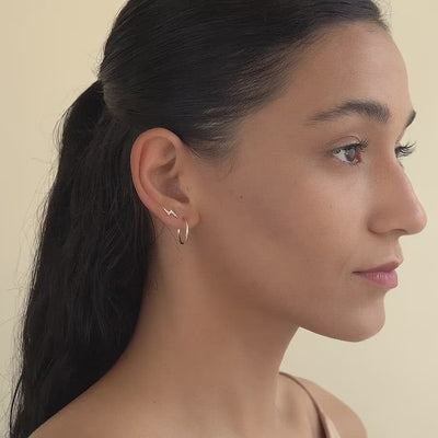 Side profile of woman featuring Gold Filled Thin Small Hoops